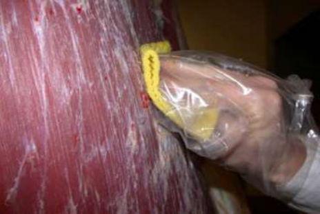 A sponge swab being used on a carcase