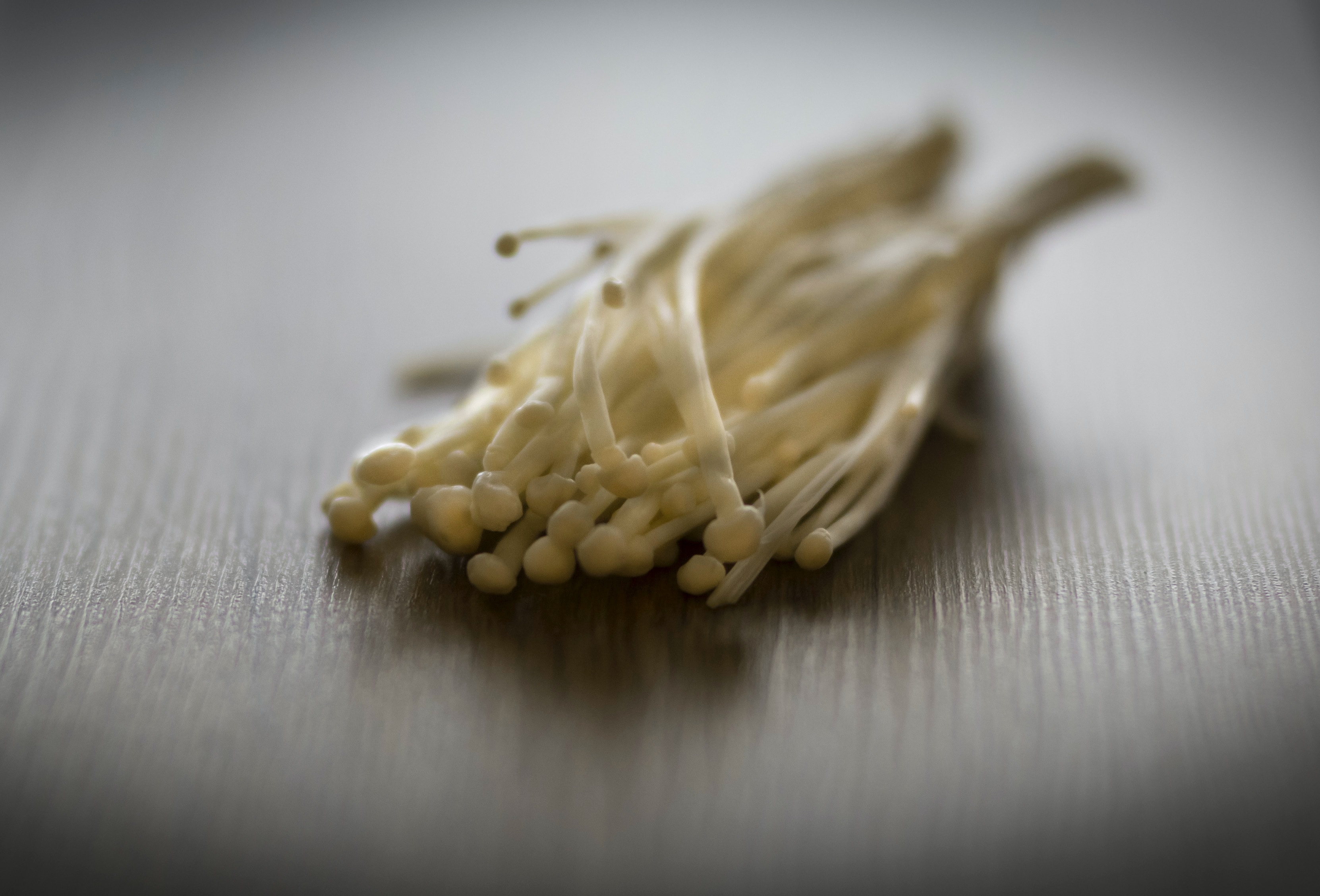 Enoki mushrooms on a table surface