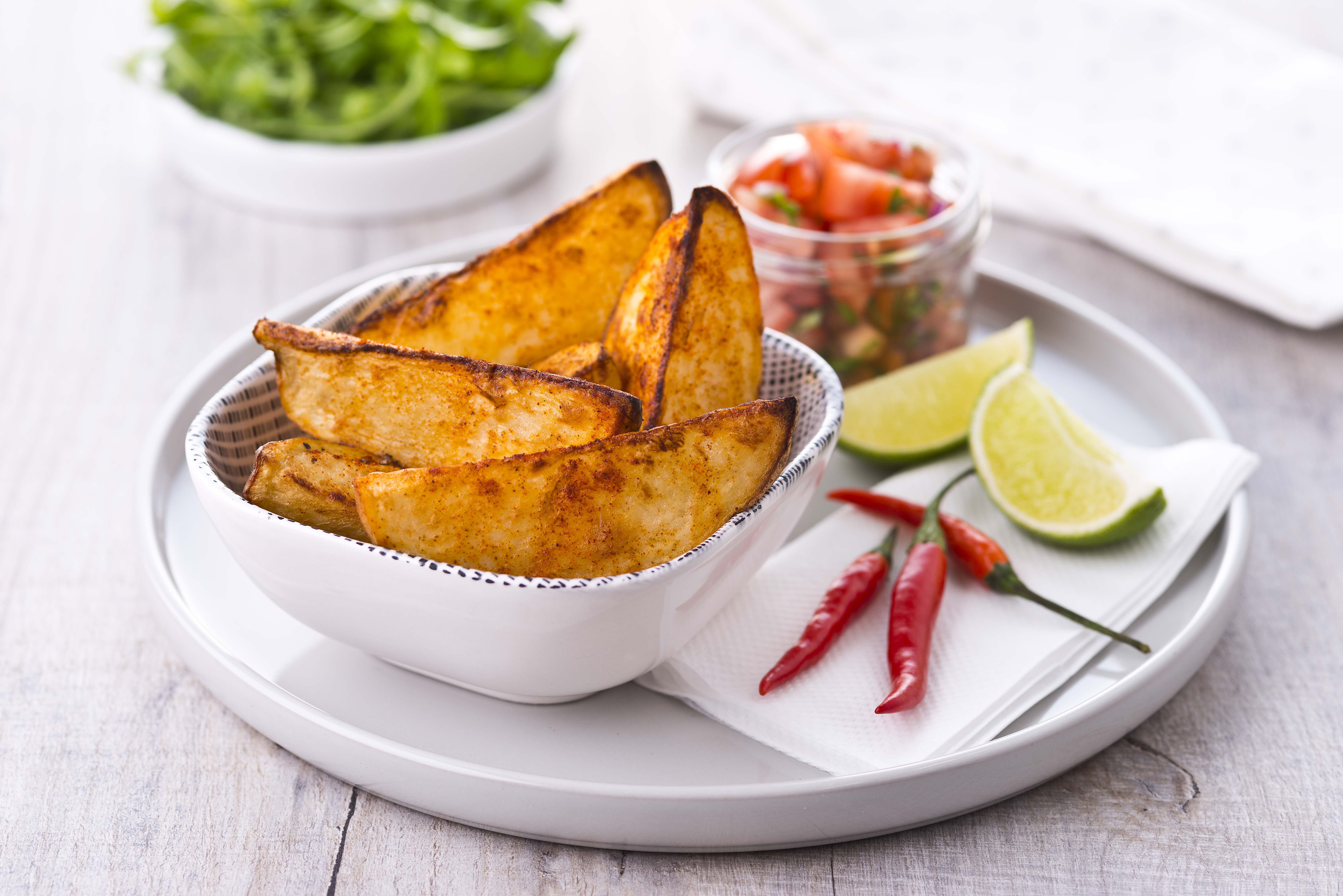 Potato wedges served with a slice of lime