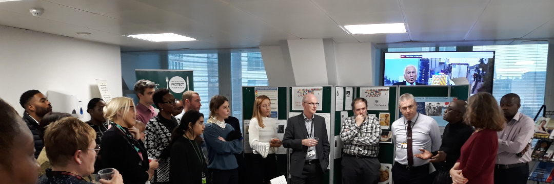 Food Standards Agency staff stood listening to someone speak