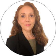 A woman with curly long hair wearing a black jacket